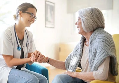 caregiver speaks with old women