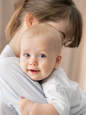 newborn baby lies swaddled in a white blanket newborn baby lies swaddled in a white blanket