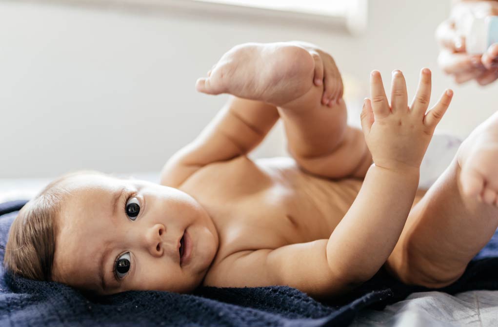 Mother changing baby's diaper