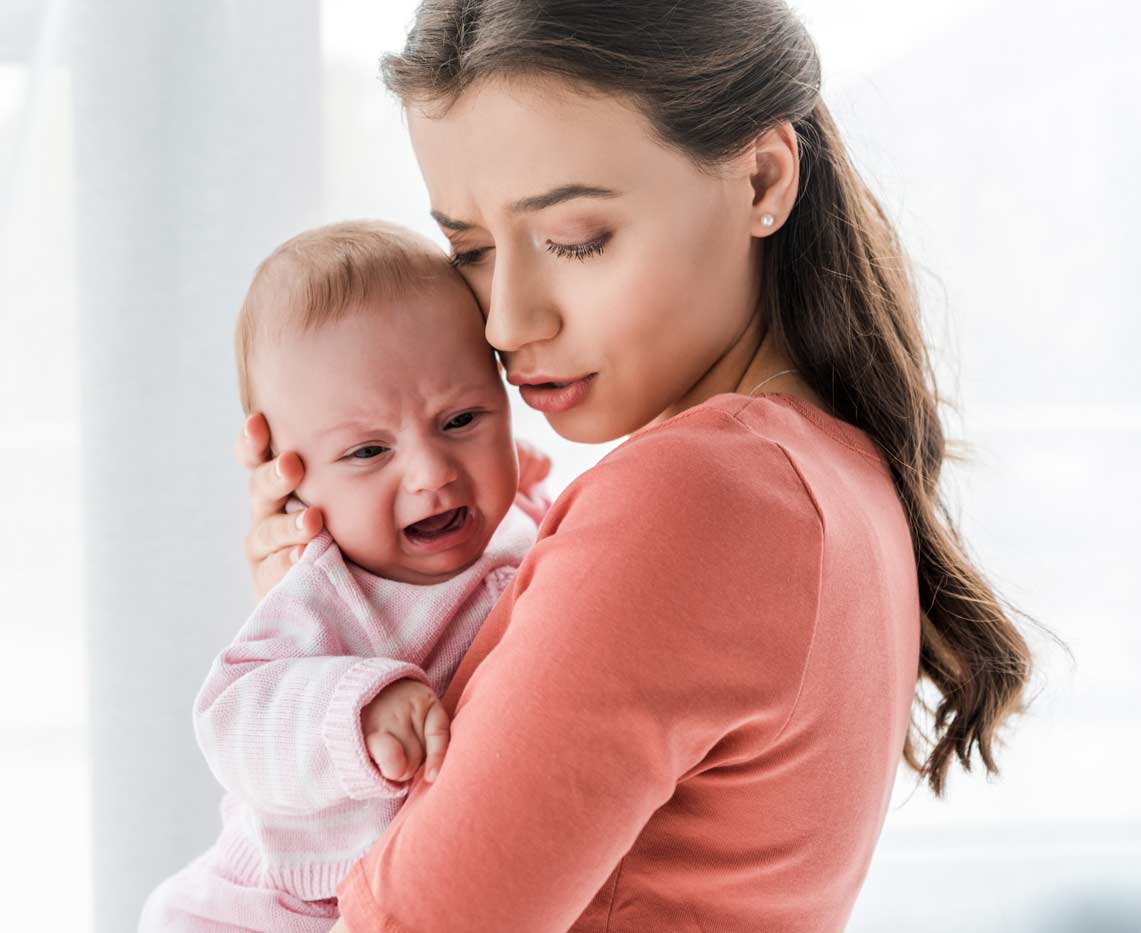 mother holding crying infant mother holding crying infant